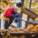 A determined homeowner intently cleaning debris from a gutter using a sturdy ladder and gloves, surrounded by fallen leaves and maintenance tools in cinematic lighting with rich colors and shallow depth of field, capturing the focus and satisfaction of a DIY home repair moment.