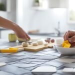A close-up cinematic scene of determined hands carefully peeling a stylish, geometric peel-and-stick tile and aligning it precisely on a clean kitchen wall above a countertop scattered with cutting tools and tile samples, bathed in warm, natural light with shallow depth of field and rich colors capturing the focused, satisfying moment of a budget-friendly kitchen makeover in progress.